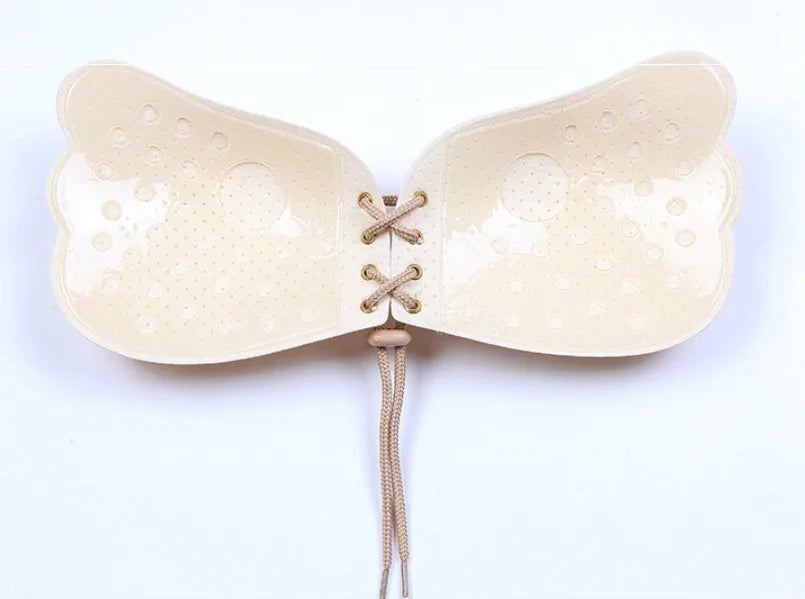 Beige adhesive strapless bra with lace-up back and breathable design for comfort and support