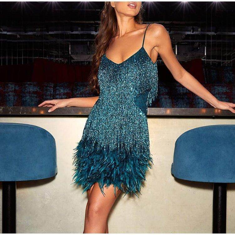 Teal sequin mini dress with feather hem, perfect for nightlife and evening events.