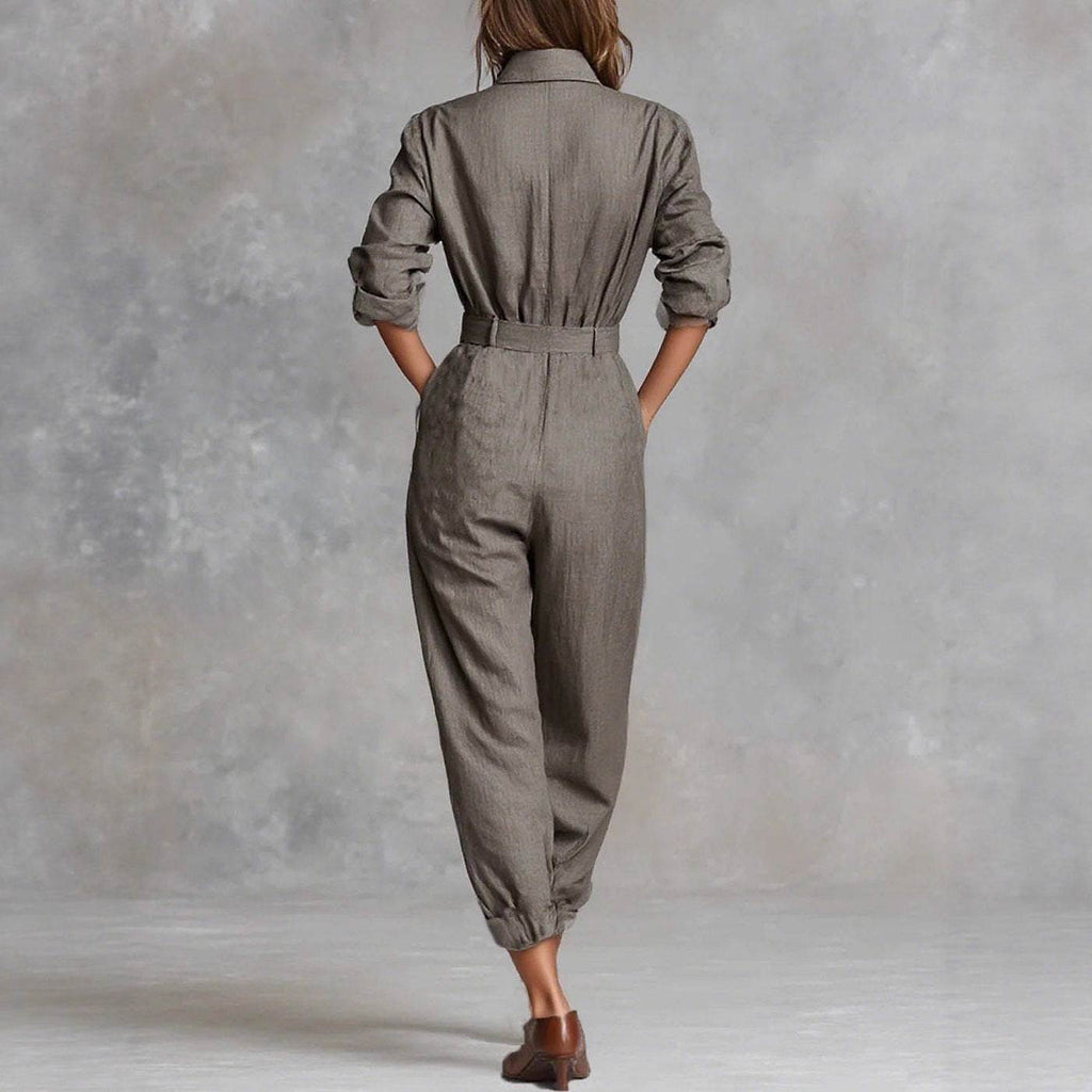Woman wearing gray belted jumpsuit with rolled sleeves, back view, for everyday elegance and comfort