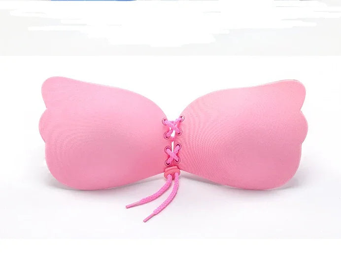 Pink strapless adhesive bra with lace-up front for seamless wear and comfort