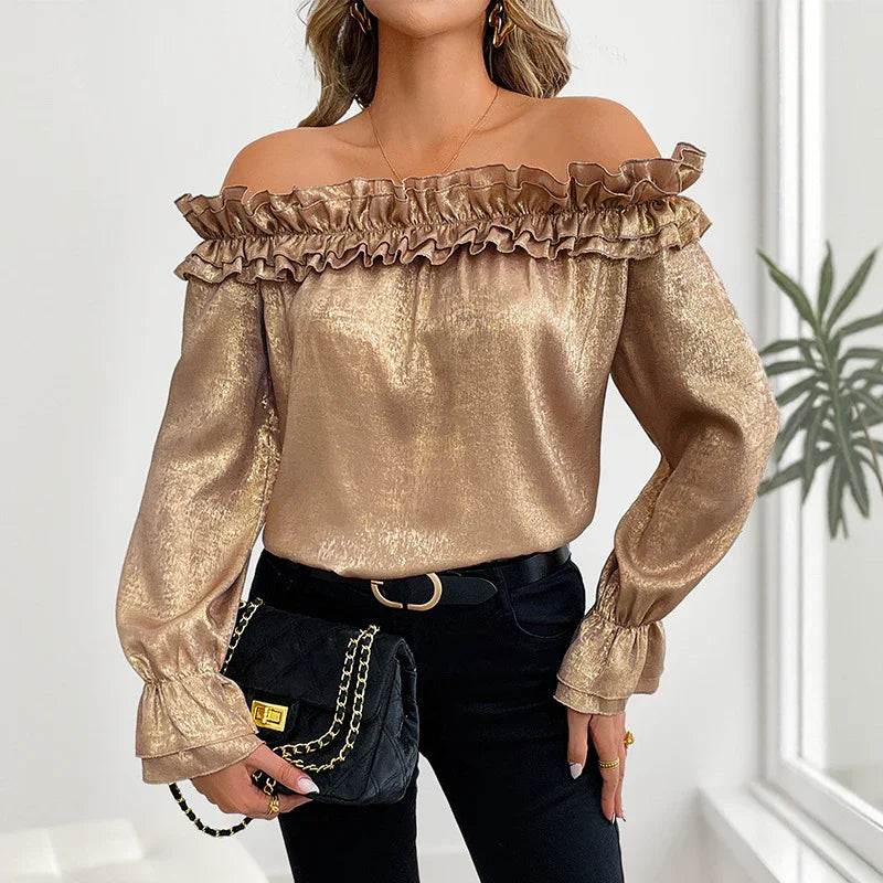Gold off-shoulder ruffle blouse with long sleeves, paired with black jeans and a chain bag for elegant everyday wear.