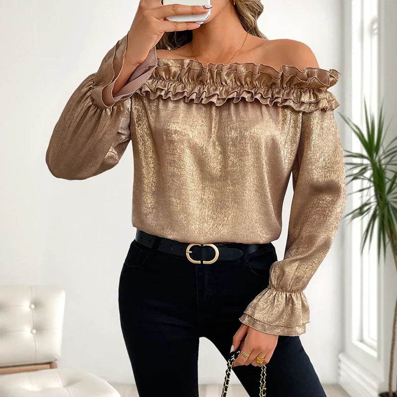 Gold off-shoulder ruffle blouse with long sleeves, paired with black jeans and belt for elegant women's fashion