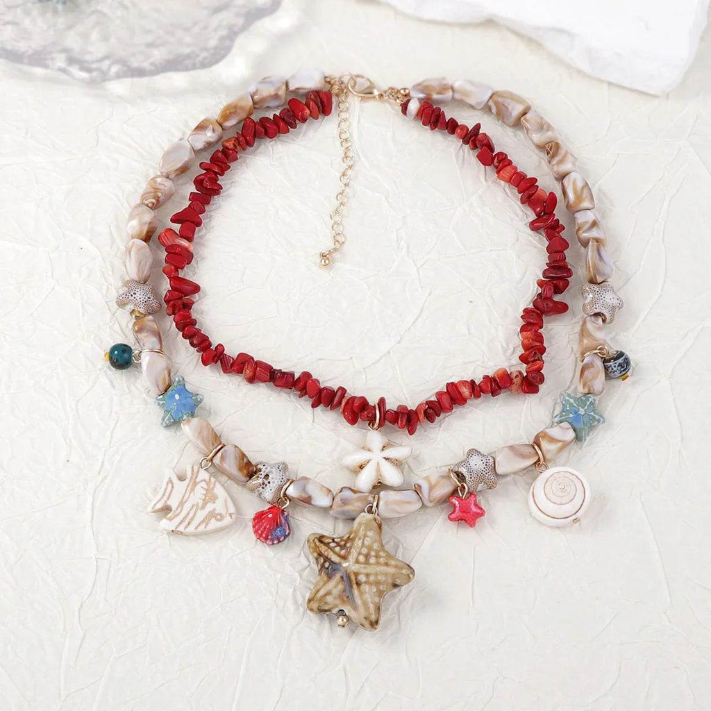Layered beach necklace with red coral, shell beads, and starfish charms for coastal style