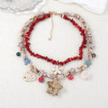 Layered beach necklace with red coral, shell beads, and starfish charms for coastal style