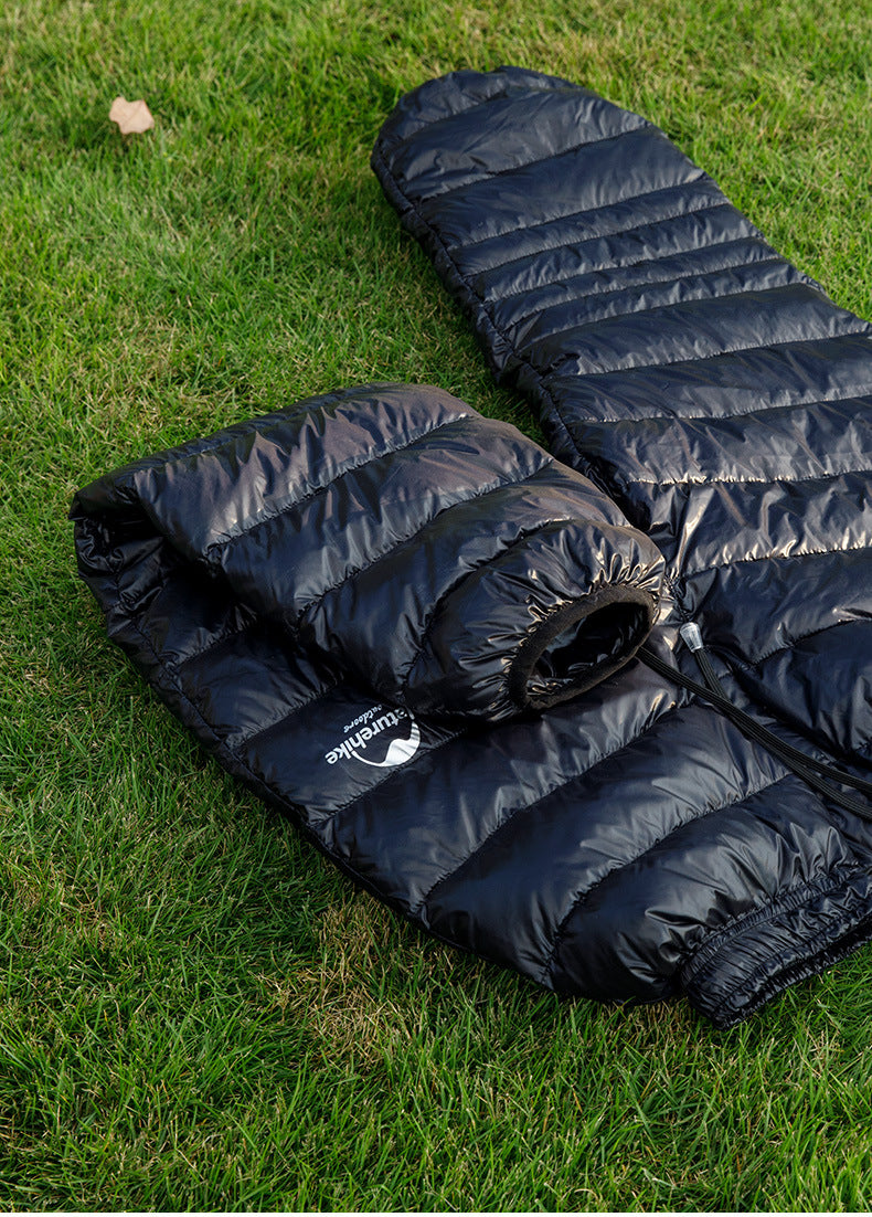 Laylace black goose down puffer pants with elastic cuffs and drawstring waist, laid flat on green grass.