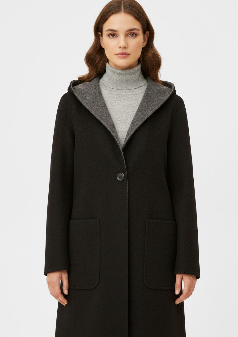 Laylace black and grey double-sided wool hooded mid-length coat worn by a model over a grey turtleneck sweater