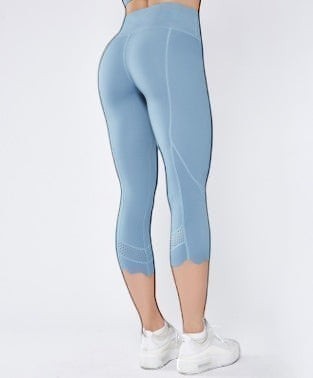 Laylace high waisted athletic cropped leggings in light blue with scalloped hem and laser-cut mesh calf detailing.