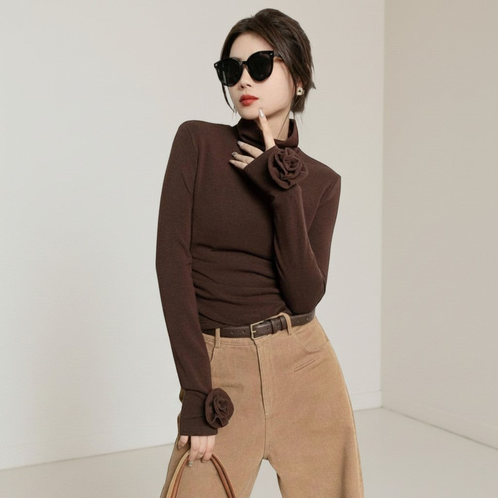 Laylace brown long sleeve turtleneck top featuring 3D rose floral cuff accents worn by a woman in sunglasses