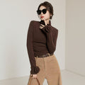 Laylace brown long sleeve turtleneck top featuring 3D rose floral cuff accents worn by a woman in sunglasses