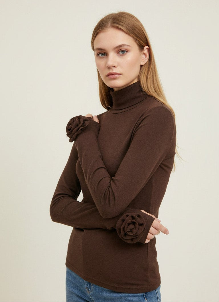 Laylace brown long sleeve turtleneck top with 3D rose floral cuffs worn by a model against a neutral background