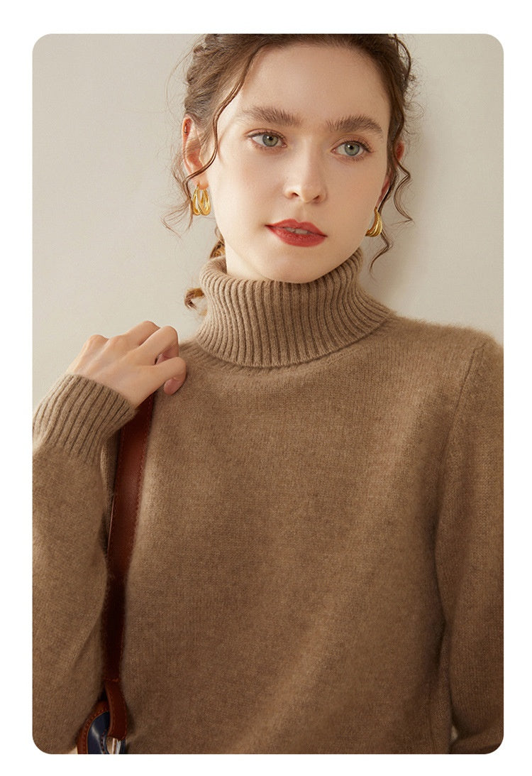 A woman wearing a Laylace thick camel cashmere turtleneck sweater with a cozy ribbed high neckline.