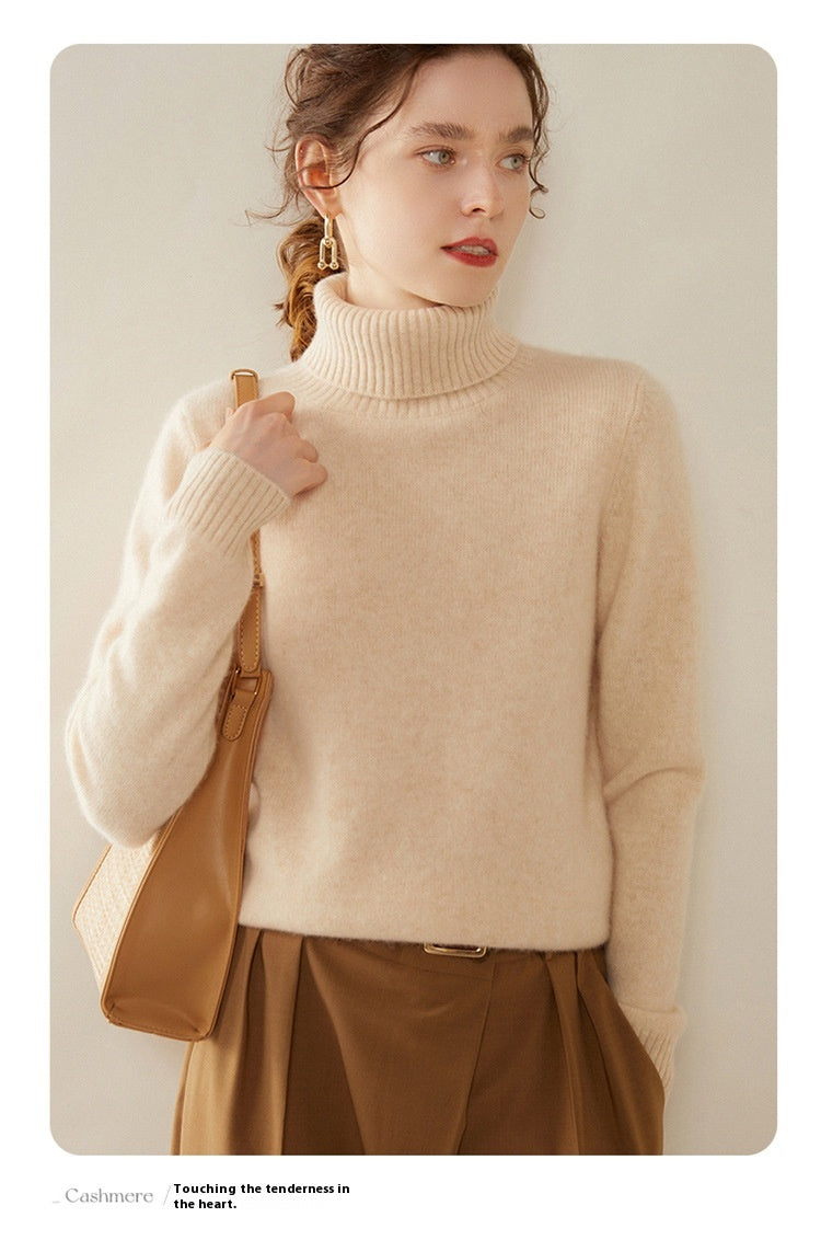 Laylace women's thick camel cashmere turtleneck sweater with long sleeves worn with a brown shoulder bag