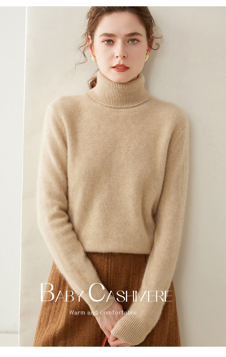 A woman wearing a Laylace camel cashmere turtleneck sweater with a thick knit and long sleeves.