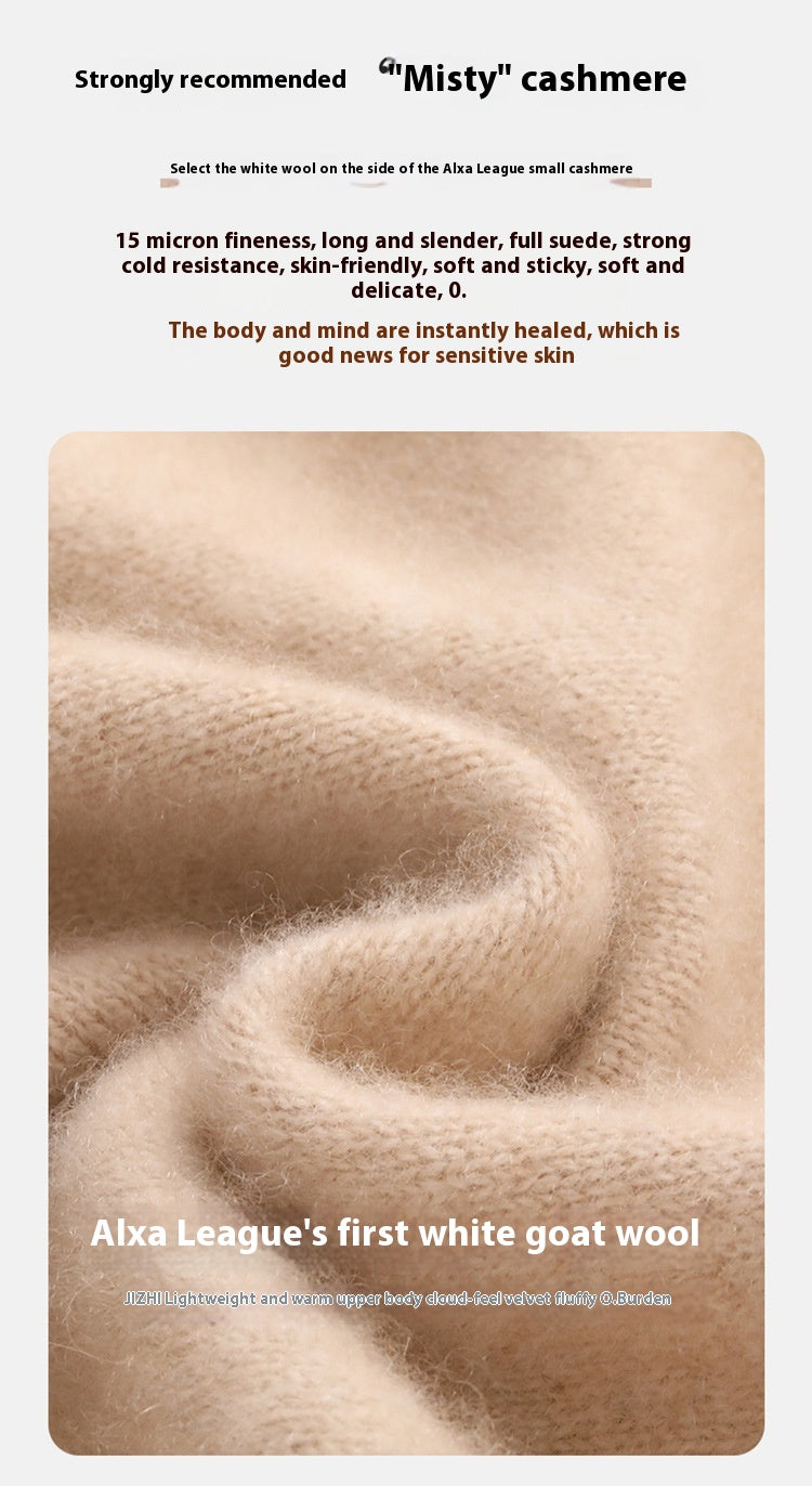 Close-up of the soft, thick beige cashmere knit fabric of a Laylace turtleneck sweater showing fine fiber texture.