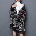 Laylace red black and white houndstooth imitation mink shawl cardigan with tassel trim worn over a white turtleneck