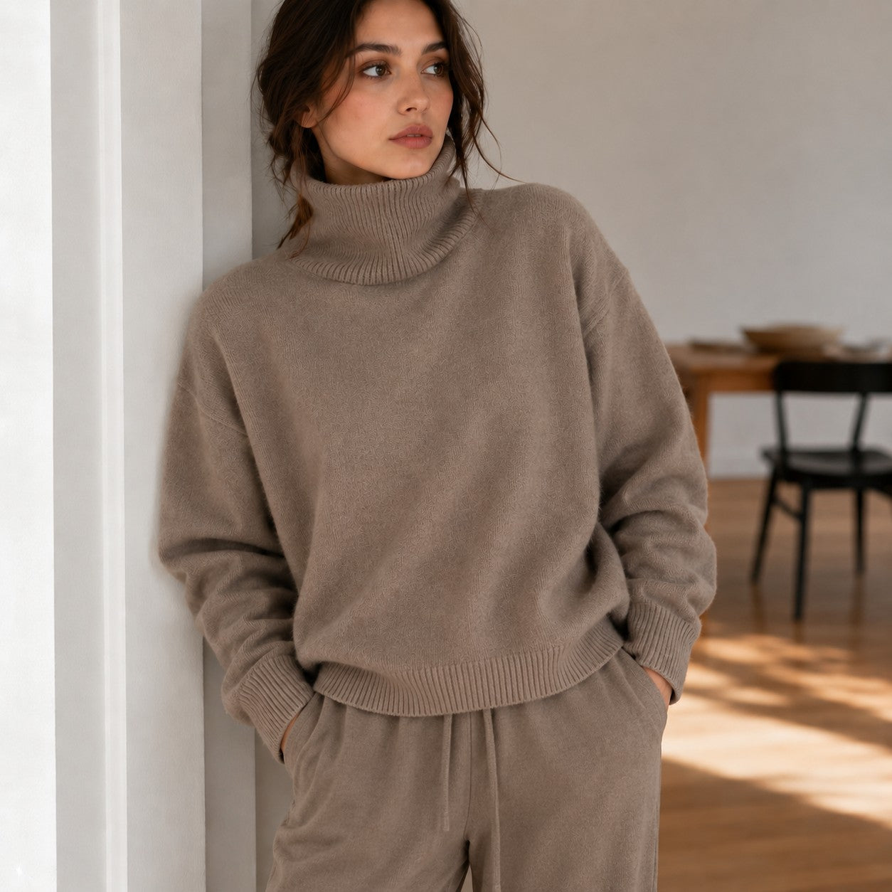 Laylace khaki knitted turtleneck sweater with long sleeves worn by a woman in a relaxed indoor setting