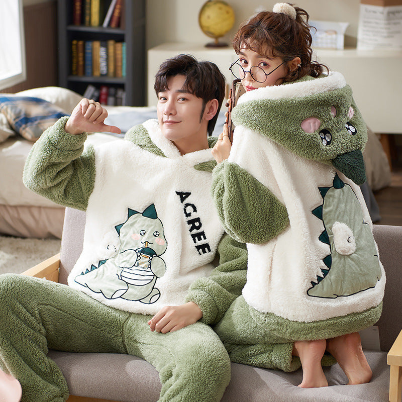 Laylace couple wearing matching green and white flannel dinosaur hooded pajama suits for winter home comfort