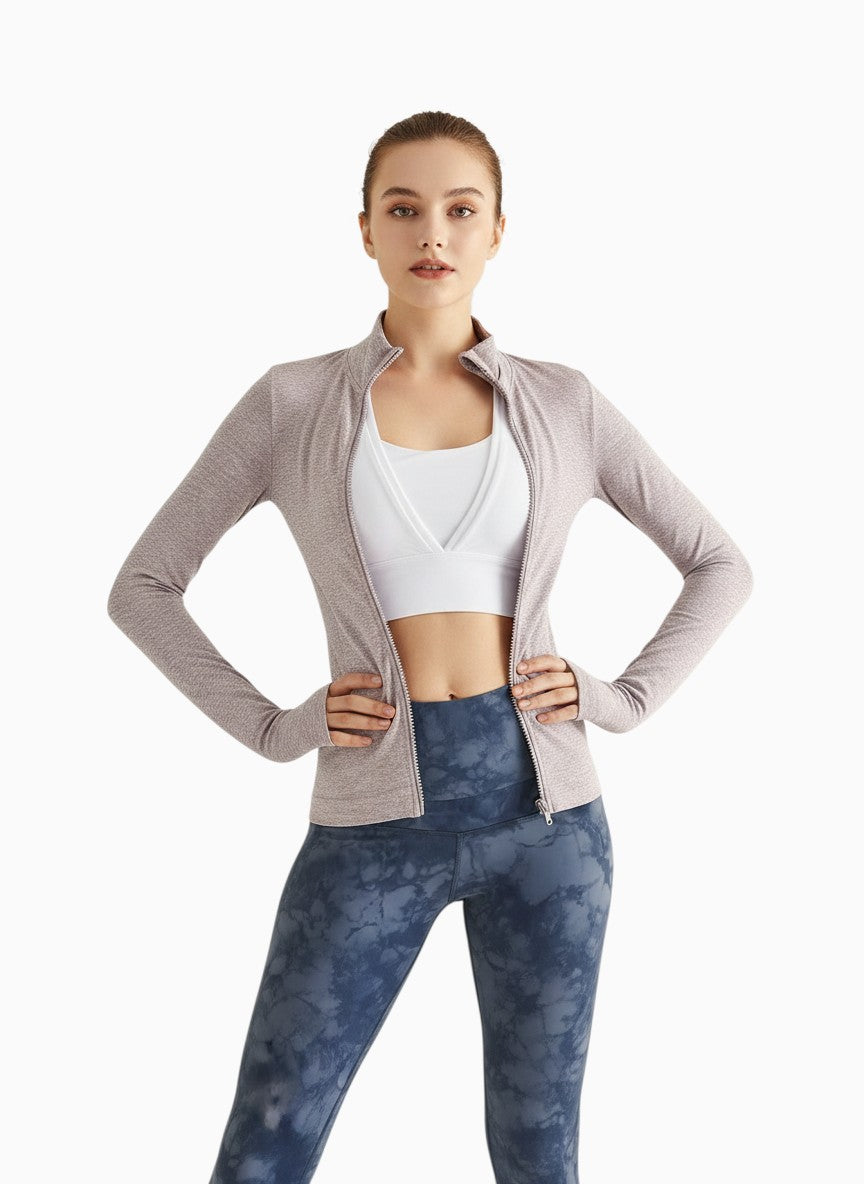 Laylace oat purple seamless long sleeve yoga cardigan with a front zipper worn by a model over a white sports bra