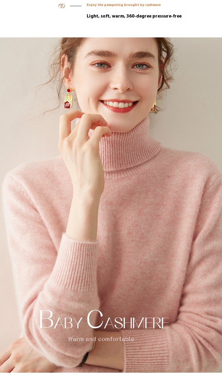 A smiling woman wearing a soft pink Laylace thick cashmere turtleneck sweater with long sleeves.