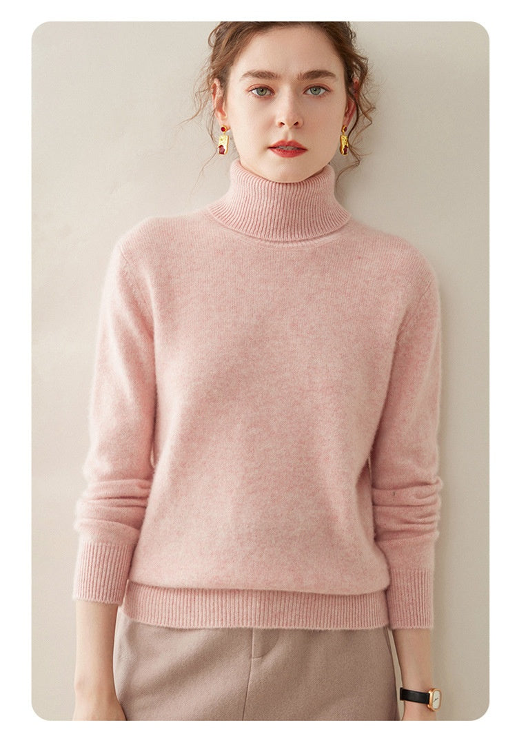 Model wearing a Laylace cherry blossom pink thick cashmere turtleneck sweater with long sleeves and ribbed trim.