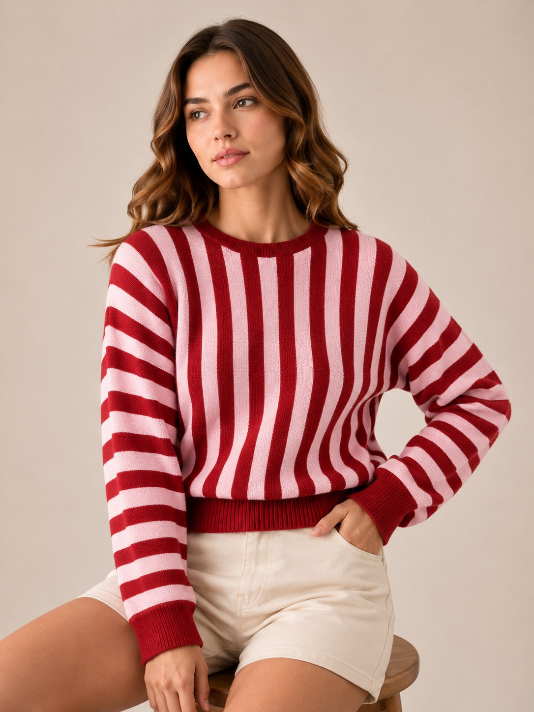 Laylace women's red and pink striped long-sleeve knit pullover sweater worn with light-colored shorts