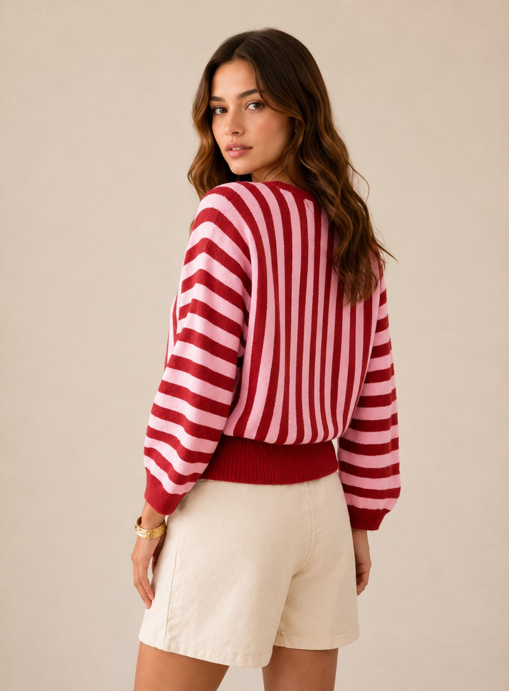 Laylace women's long-sleeve knit pullover featuring a red and pink vertical striped pattern, worn by a model.