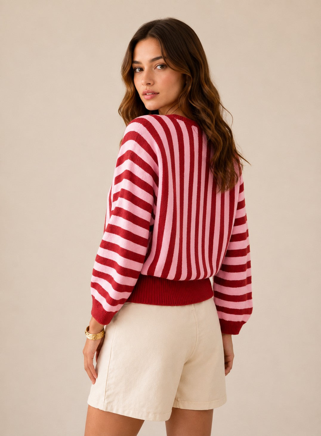 Laylace women's long-sleeve knit pullover featuring a red and pink vertical striped pattern, worn by a model.