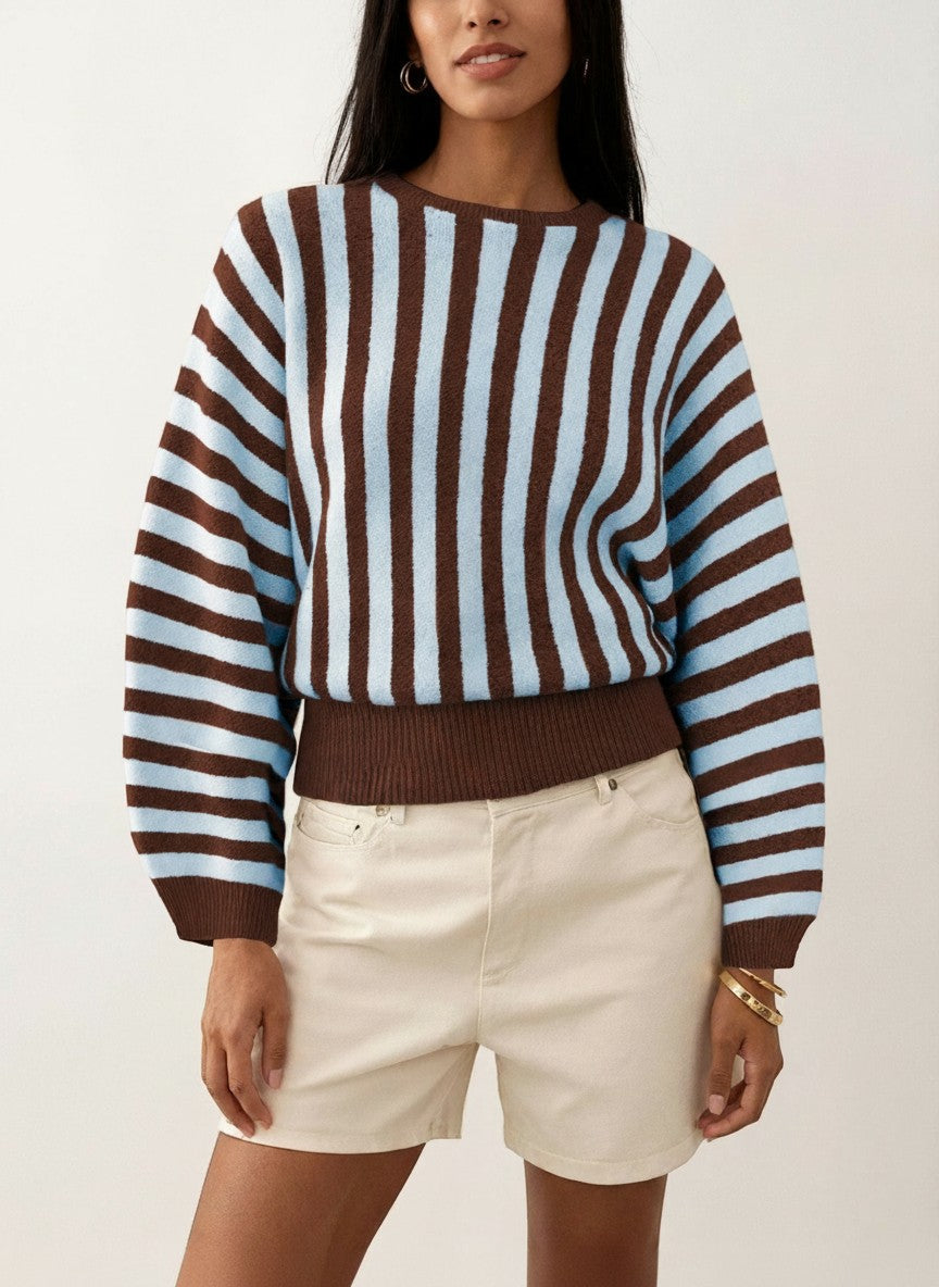 Laylace long-sleeve knit pullover featuring vertical blue and brown stripes on a model wearing cream shorts