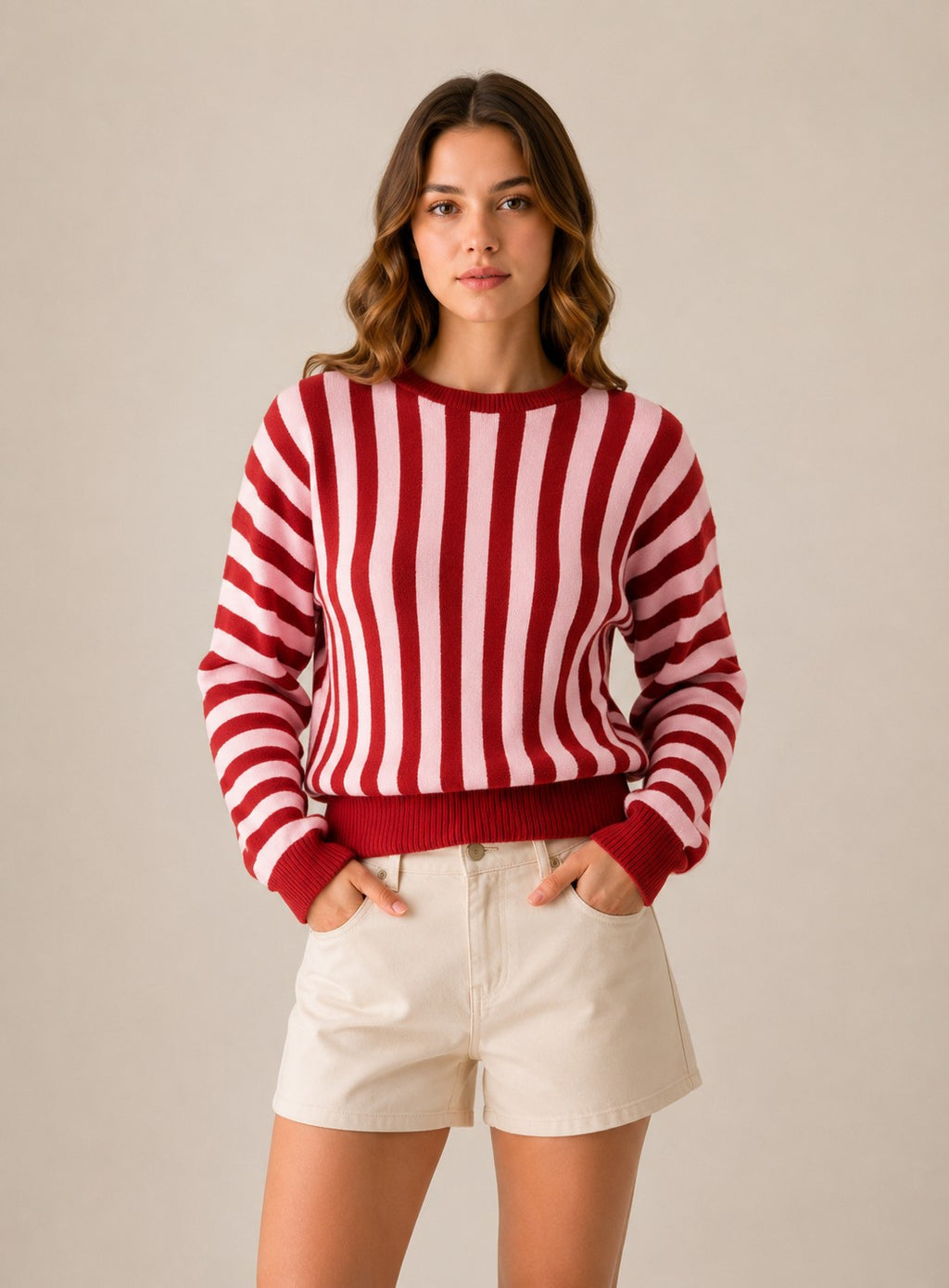 Laylace women's red and pink vertical striped long-sleeve knit pullover sweater worn with cream shorts