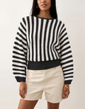 Laylace black and white vertical striped long-sleeve knit pullover sweater worn with beige shorts