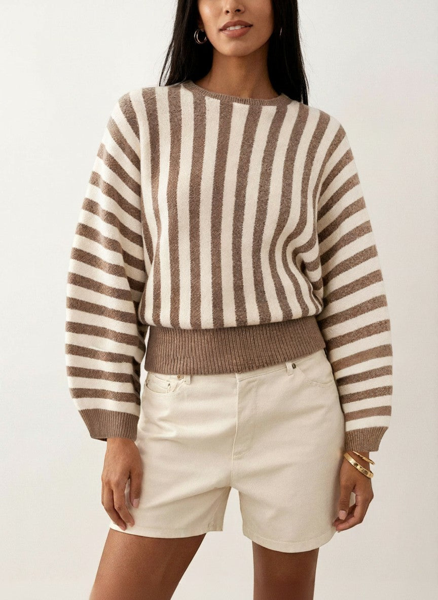 Laylace long-sleeve knitted pullover featuring vertical brown and cream stripes worn by a model with white shorts