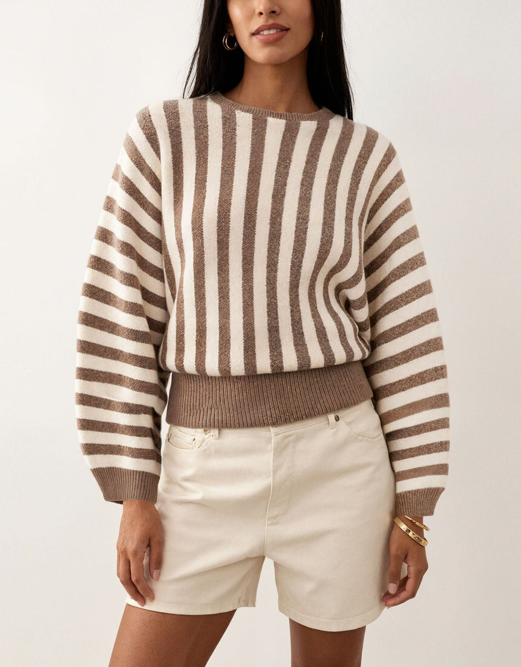 Laylace long-sleeve knit pullover featuring vertical brown and khaki stripes with a ribbed hem and crew neckline