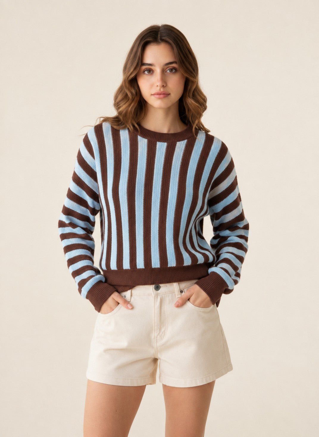 Laylace women's long-sleeve knit sweater featuring vertical brown and light blue stripes worn with beige shorts