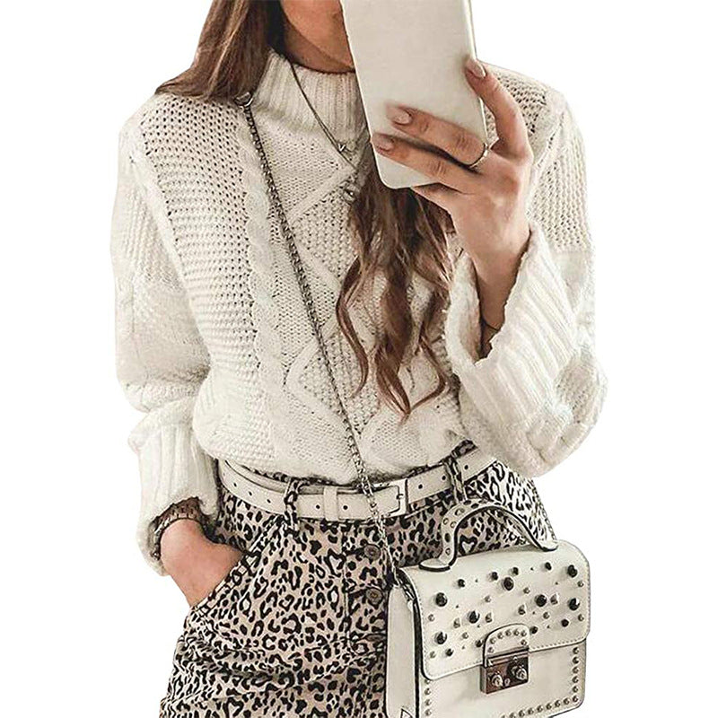 Laylace white long-sleeve cable knit sweater with a round neck worn by a woman with a leopard print skirt