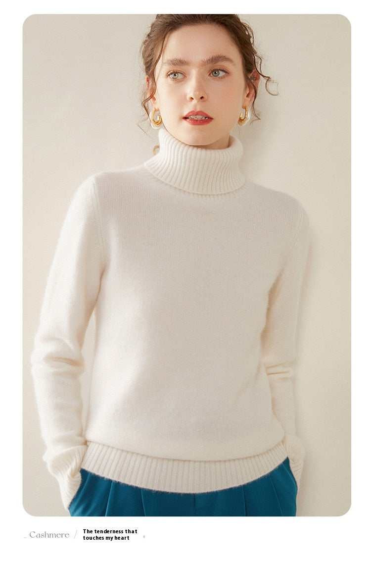 A woman wearing a Laylace white cashmere turtleneck sweater with a thick ribbed knit design.